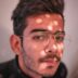 man in black crew neck shirt wearing silver framed eyeglasses