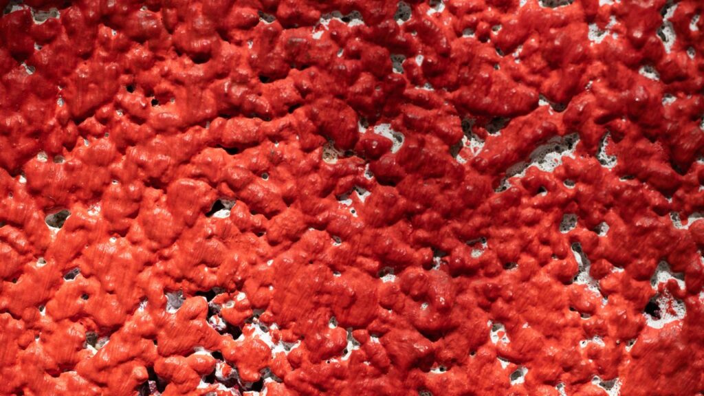 a close up of a red and black surface