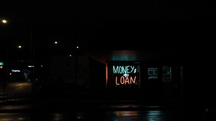 a neon sign is lit up in the dark