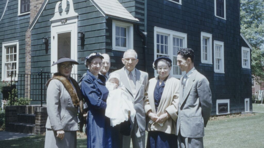 group of people standing near house
