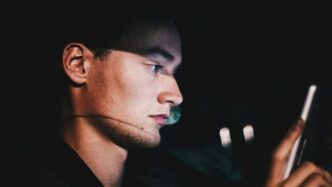 man using phone during nighttime