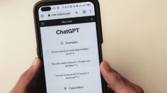 a person holding a cell phone with a chat app on the screen