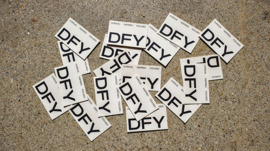 a pile of black and white stickers sitting on top of a floor