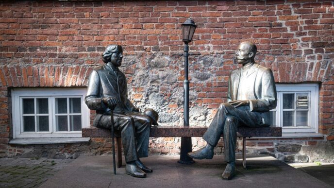 Two bronze statues sit on a bench