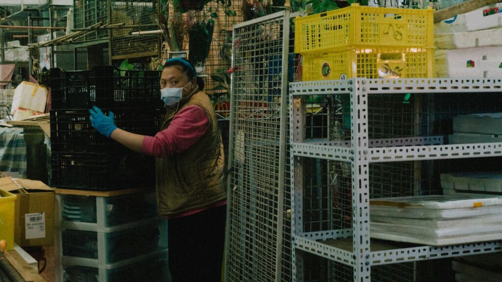 a woman wearing a face mask and gloves in a store