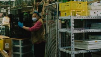 a woman wearing a face mask and gloves in a store