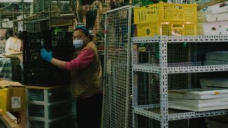 a woman wearing a face mask and gloves in a store