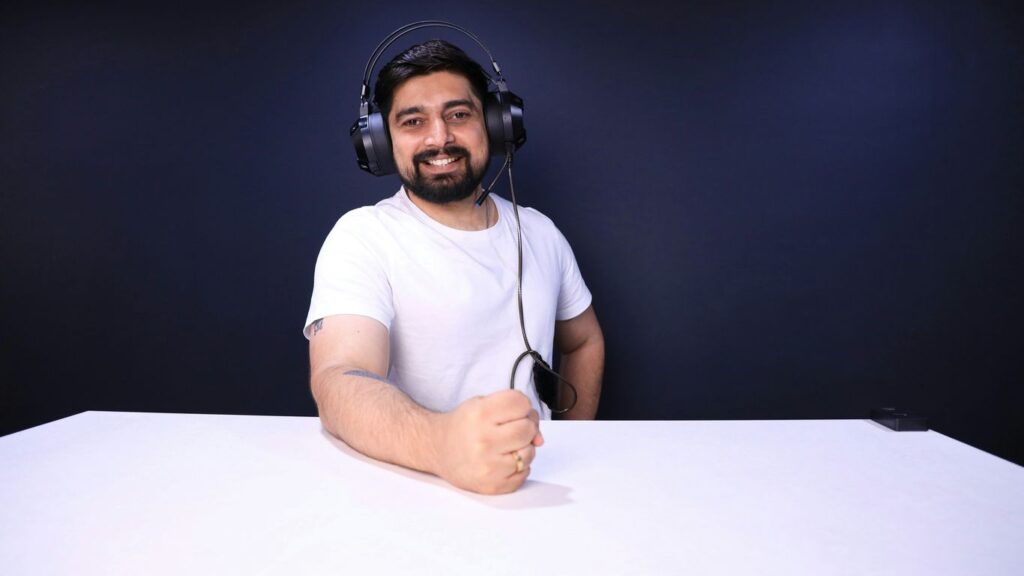 a man wearing headphones sitting at a table