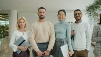 Diverse group of professionals standing together indoors.