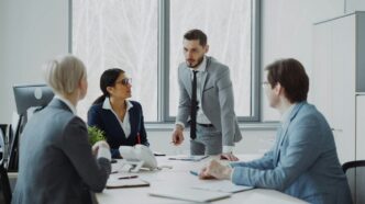 Business professionals in a meeting around a table.