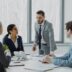 Business professionals in a meeting around a table.
