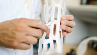 person holding white plastic clothes hanger