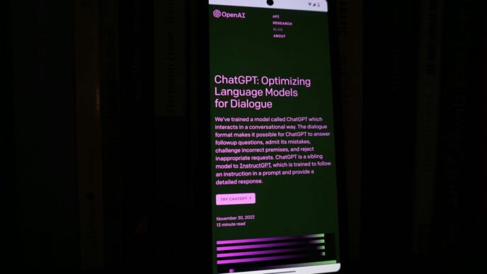 a cell phone with a lit up screen in the dark