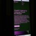 a cell phone with a lit up screen in the dark