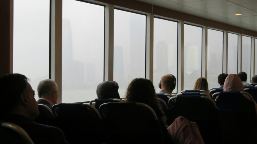A group of people sitting in chairs in front of a window