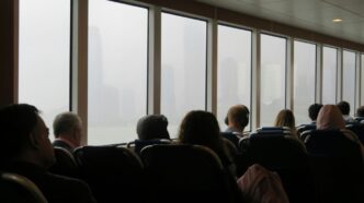 A group of people sitting in chairs in front of a window