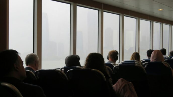 A group of people sitting in chairs in front of a window