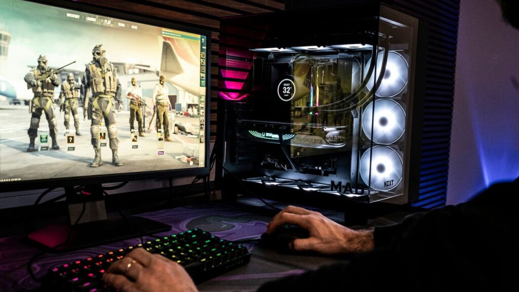 A man is playing a video game on his computer