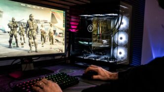 A man is playing a video game on his computer