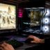 A man is playing a video game on his computer