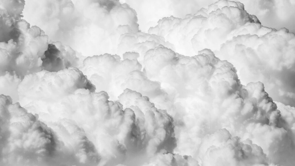 a black and white photo of clouds in the sky