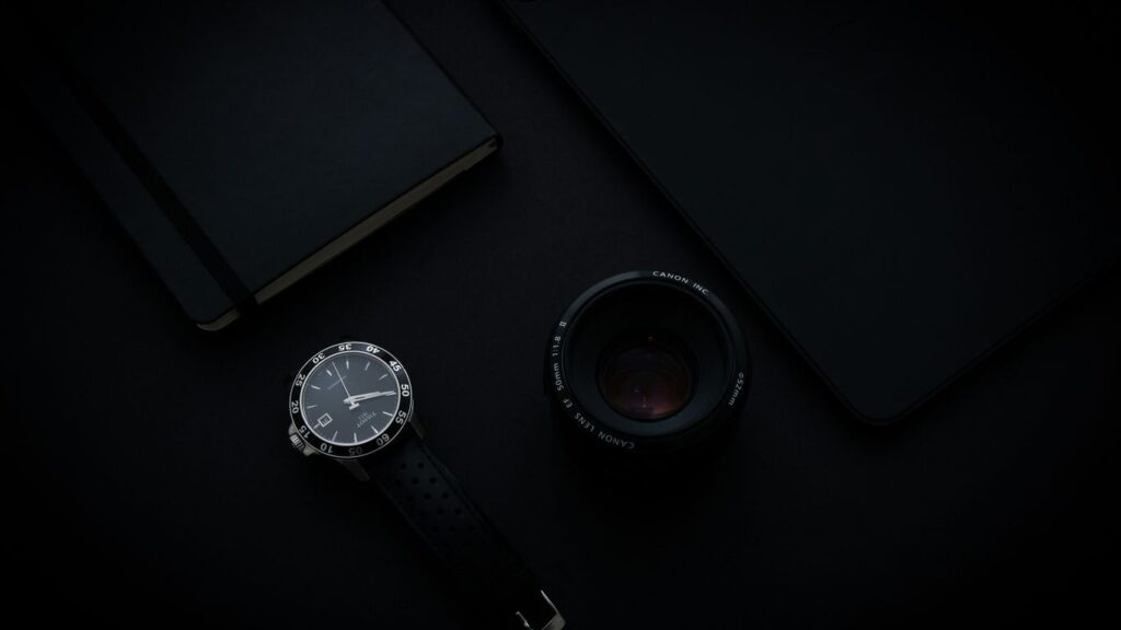 black and silver round analog watch with black leather strap