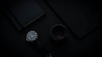 black and silver round analog watch with black leather strap