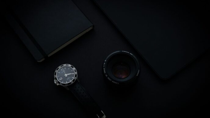 black and silver round analog watch with black leather strap