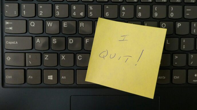 a yellow notepad on a keyboard
