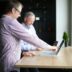 man in purple and white checkered dress shirt using macbook pro