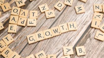 scrabbled letters spelling growth on a wooden surface