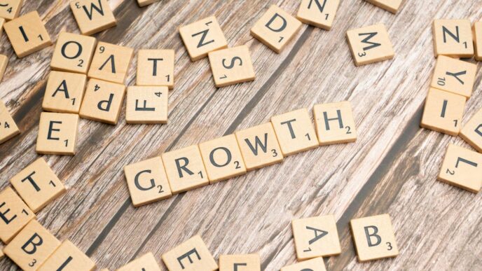 scrabbled letters spelling growth on a wooden surface