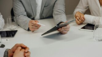 a group of people sitting around a white table