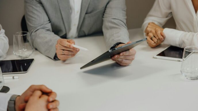 a group of people sitting around a white table