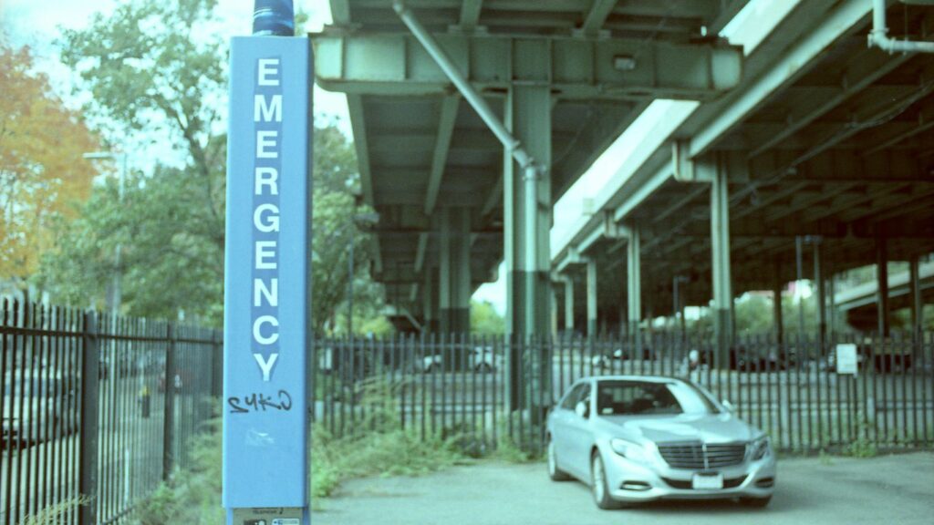 a car is parked in front of a sign
