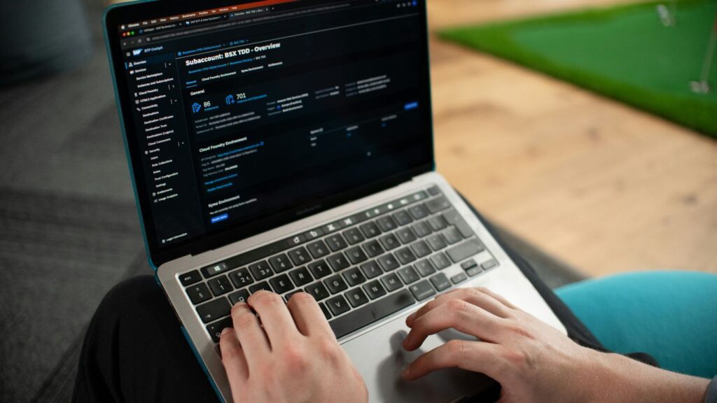 Hands typing on a laptop computer screen