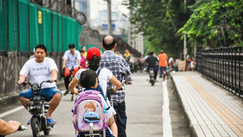 a group of people riding bikes down a street