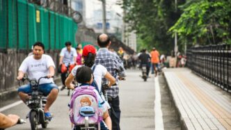 a group of people riding bikes down a street