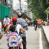 a group of people riding bikes down a street