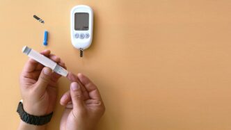 a person holding a thermometer next to an electronic device
