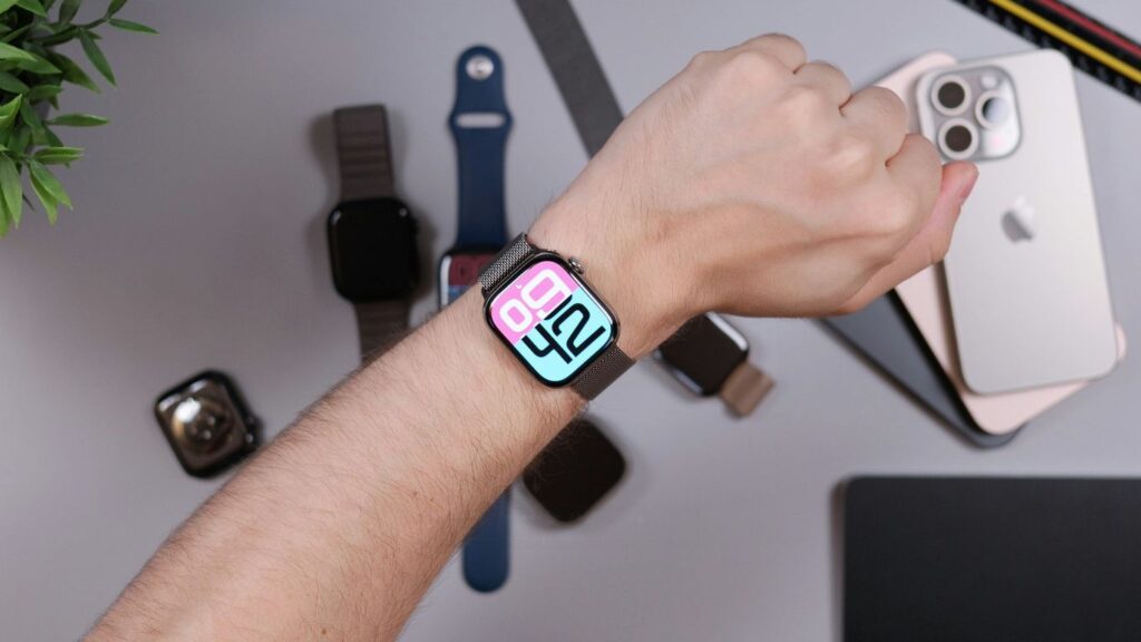 Person wearing smartwatch with iphones and bands