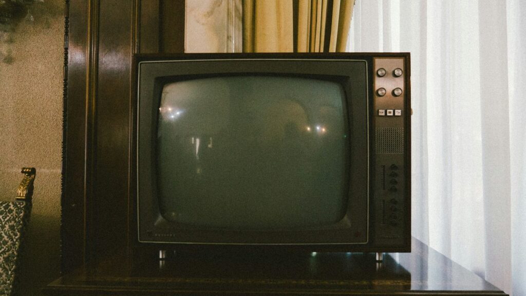 turned-off gray CRT TV on table