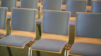 a row of blue chairs sitting in a room