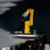 a yellow robot sitting on top of a table