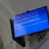 The TV displays a blue screen of death.