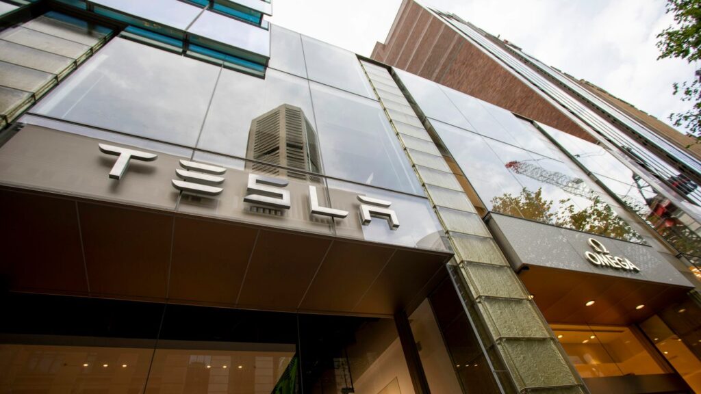 a tall building with a tesla sign on it's side