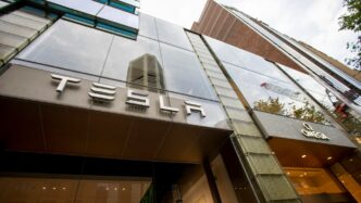 a tall building with a tesla sign on it's side
