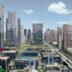 Modern city skyline with tall buildings and blue sky.