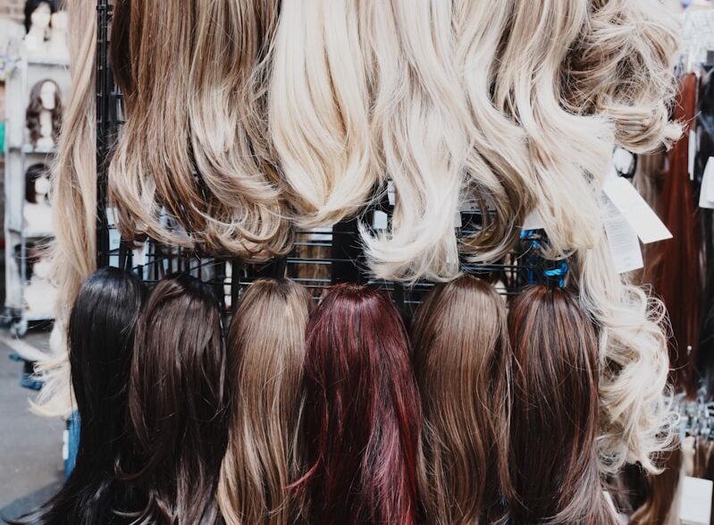 Wigs of various colors are displayed.