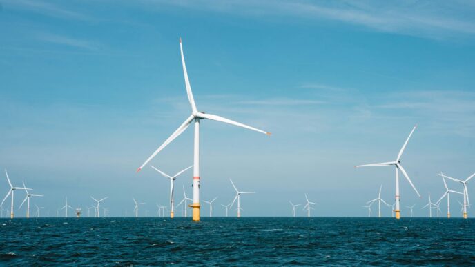 a group of wind turbines in the ocean